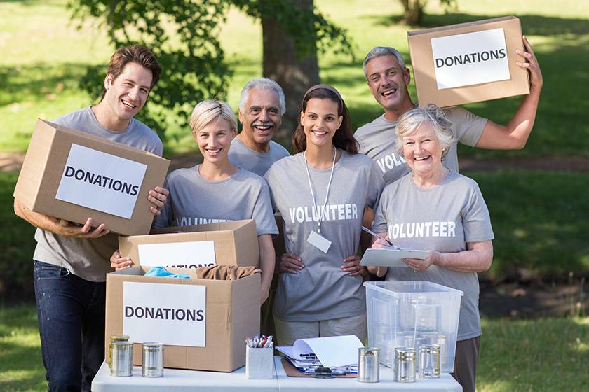 Volunteer family holding donations boxes